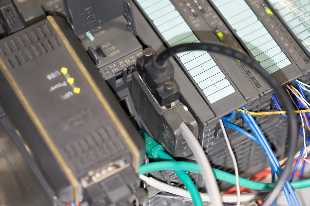 Close-up of a PLC control panel with industrial automation wiring and modules.