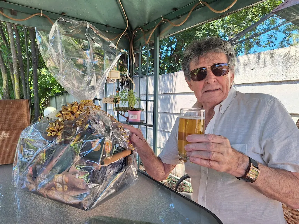 Jeff Sharman holding a drink outdoors, reflecting a personal moment behind his motivation for teaching.